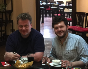 Photo of collaborators Martin Fenner and Joe Wass enjoying a meal together. 
